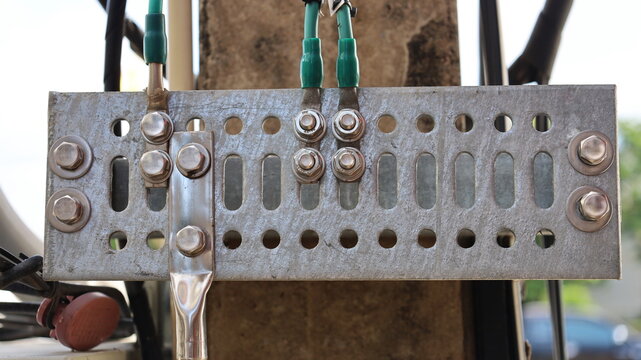 Ground bar with earth wire cable on pole. The lightning protection grounding system of the mobile telecommunication substation transmits Wi-Fi signals. Close focus and select the subject