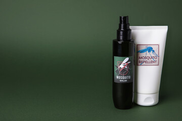 Mosquito repellent cream and spray on green background
