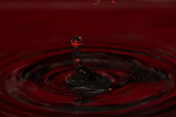 Water splash hand playing with water orbs - stock photo