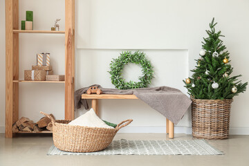 Beautiful Christmas tree with mistletoe wreath in interior of room
