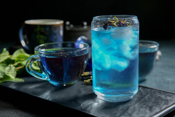Glass of iced blue tea on table, closeup