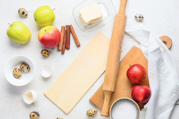 Fresh dough and ingredients for apple strudel on white background