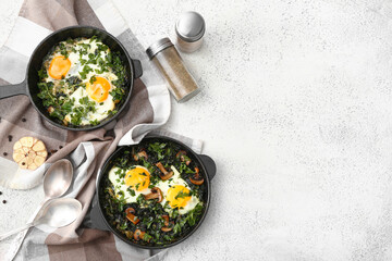 Frying pans with tasty Shakshouka on white background