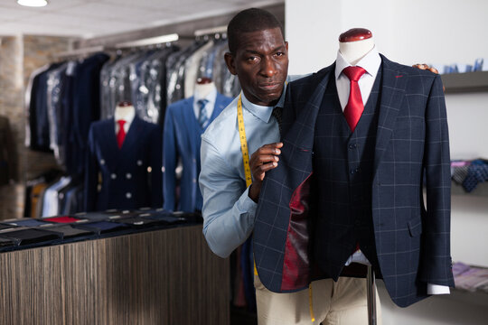 Person is creating business image with red tie in store. High quality photo