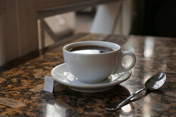 Cup of hot tea on table in cafe