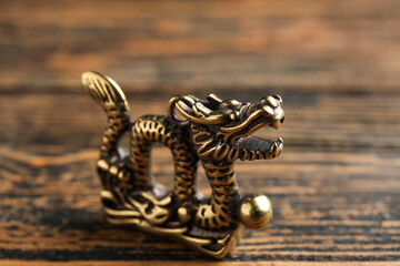 Fototapeta na wymiar Figurine of Chinese dragon on wooden background