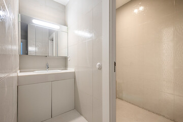 Fototapeta na wymiar Toilet with large stoneware tiles tiling walls and floors