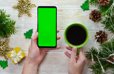 green screen technology cell phone on christmas decoration table top view flat lay, mock up for...