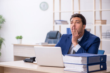 Fototapeta premium Young male employee and too much work in the office