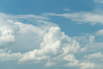 Cumuliform cloudscape on sky. Panorama. The sun is hidden.  Cumulonimbus clouds.