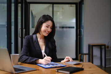 Happy Business woman working to analyze technical price graph and indicator.