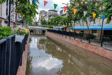 Khlong Ong Ang canal with flags in downtown Bangkok Thailand