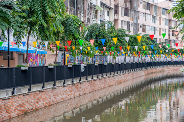 Khlong Ong Ang canal with flags in downtown Bangkok Thailand