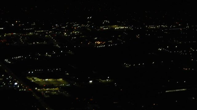 Fast Moving Airplane Aerial Over City Skyline Night Lights In Evening