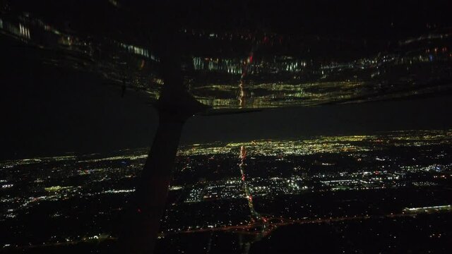 Reflection Of City Skyline In Airplane Wing At Night