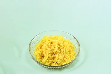Cooked Yellow Rice in a Plate, Portion of Steamed Yellow Rice (Nasi Kuning) with Turmeric, Copy Space for Text
