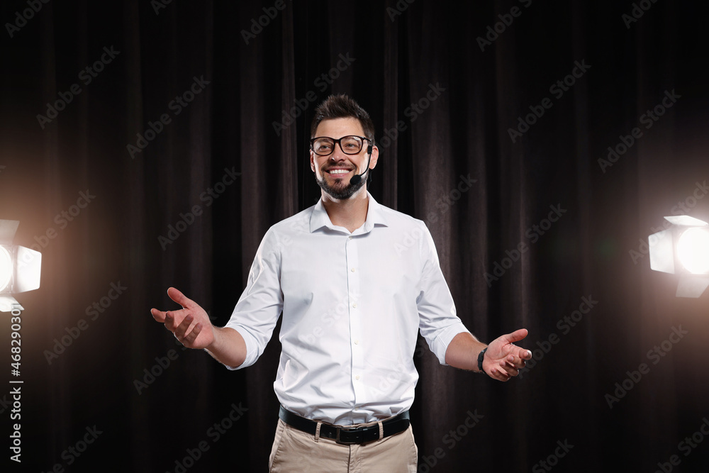Wall mural Motivational speaker with headset performing on stage