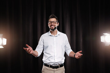 Motivational speaker with headset performing on stage