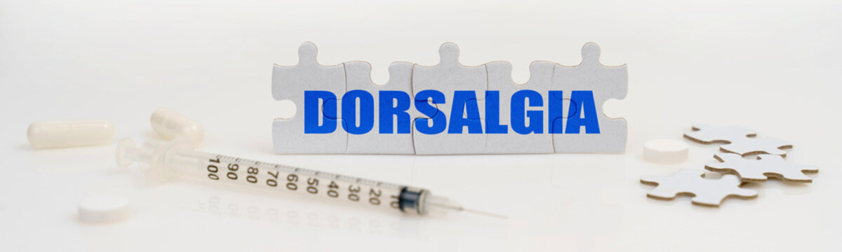 On a white background lie a syringe, pills and puzzles with the inscription - DORSALGIA