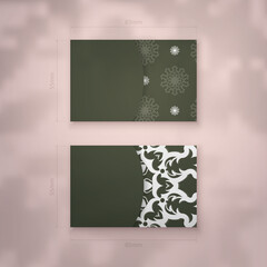 Dark green business card with vintage white ornaments for your brand.