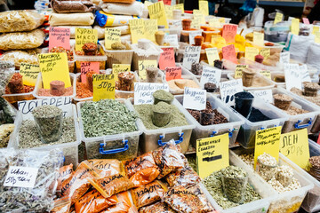 Makhachkala, Russia - October, 2021: different spices sold in the food market in Dagestan. On the plates are written the names and prices in Russian.