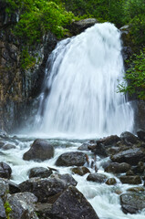 Fototapeta premium Korbu waterfall among the mountains in the Altai Mountains, UNESCO zone