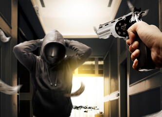 A criminal man in a hidden mask raised a hand behind the head for arrested after the robbery