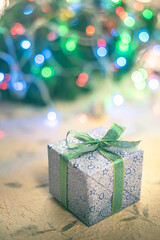 Beautiful Christmas gift boxes. Colored Presents for Birthdays. Boxes with gifts tied with ribbon and bows background. craft paper present box. Christmas tree toys and lights. happy new year 2022.