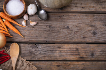 Close up of multiple food ingredients and cutlery with copy space on wooden surface