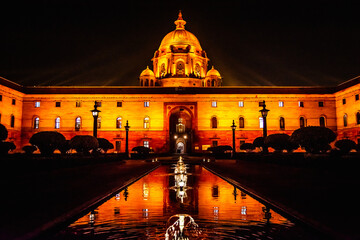 Orange light shining on the Secretariat building in New Delhi India at night time