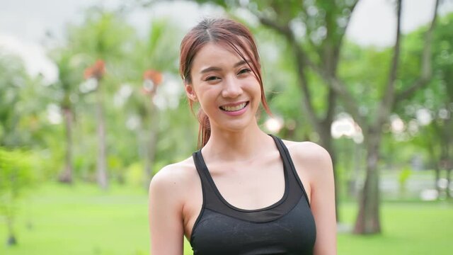 Asian active sport woman stand with confidence after exercise outdoors.