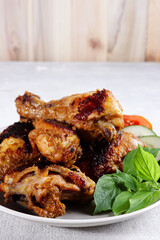 Ayam Bakar Bumbu Rujak is a Javanese food made from chicken which uses a red basic spices then grilled.