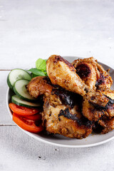 Ayam Bakar Bumbu Rujak is a Javanese food made from chicken which uses a red basic spices then grilled.