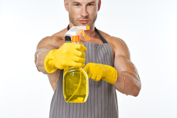 cheerful man in apron detergent posing muscles