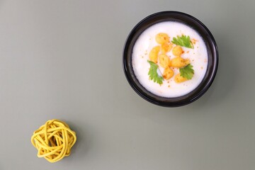 Boondi Raita or Dahi Bundi rayta is a Popular condiment from Rajasthan, India. Served with coriander toppings in a bowl over the flat background. copy space. Yogurt dip. 