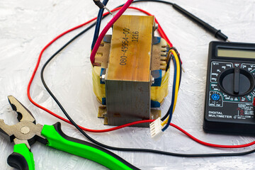 electric transformer pliers and ampervoltmeter on the table surface