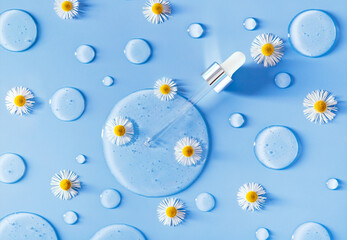serum dropper on a blue background with chamomile flowers transparent gel	
