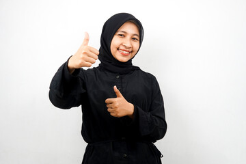 Beautiful young asian muslim woman smiling confident, enthusiastic and cheerful with hands thumbs up, ok sign, success, good job, success sign, isolated on white background