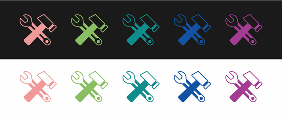 Set Crossed hammer and wrench spanner icon isolated on black and white background. Hardware tools. Vector