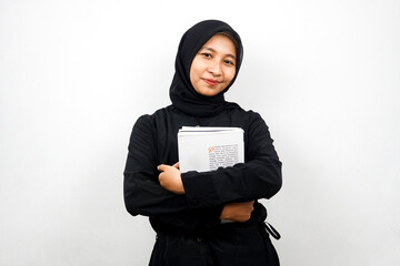 Beautiful young asian muslim woman carrying a book isolated