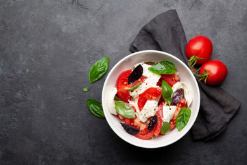 Caprese salad with fresh tomatoes, basil and mozzarella cheese