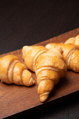 Fresh croissants on a wooden board. selective focus .bakery with copy space.