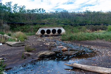 Drainage of sewage into reservoirs. Huge pipes through which waste flows into the river