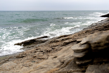 Sea waves hitting the rock. Concept of respect for nature. Copy space.