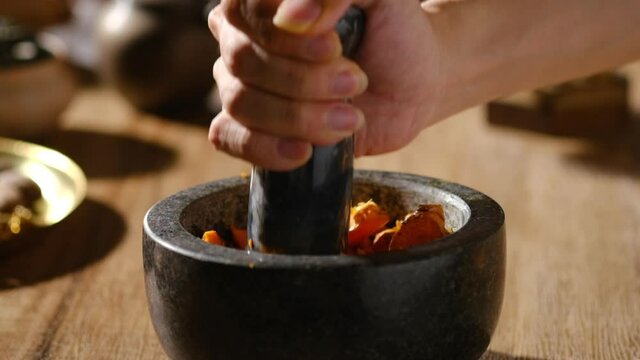 A closeup view of crashing herb and species , lighting chinese traditional medicine for advertising , healthcare content
