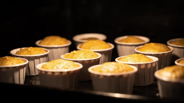 slow motion carrot muffins baked on a baking sheet in the oven