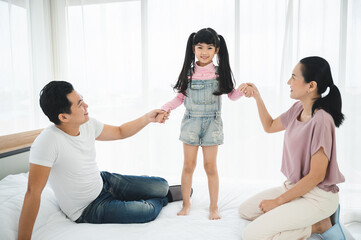 happy love family lifestyle with Asian father and mother and child daughter at home together