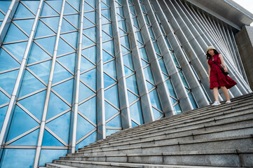 Asian woman in red dress at modern building, female girl with urban city lifestyle © chokniti