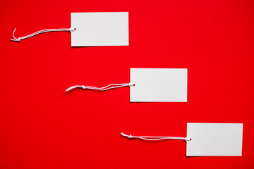 Naklejka premium Three tags on a red background. Seasonal Sale or Black Friday