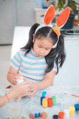 mother and child family making waster egg at home happy and fun together in holiday